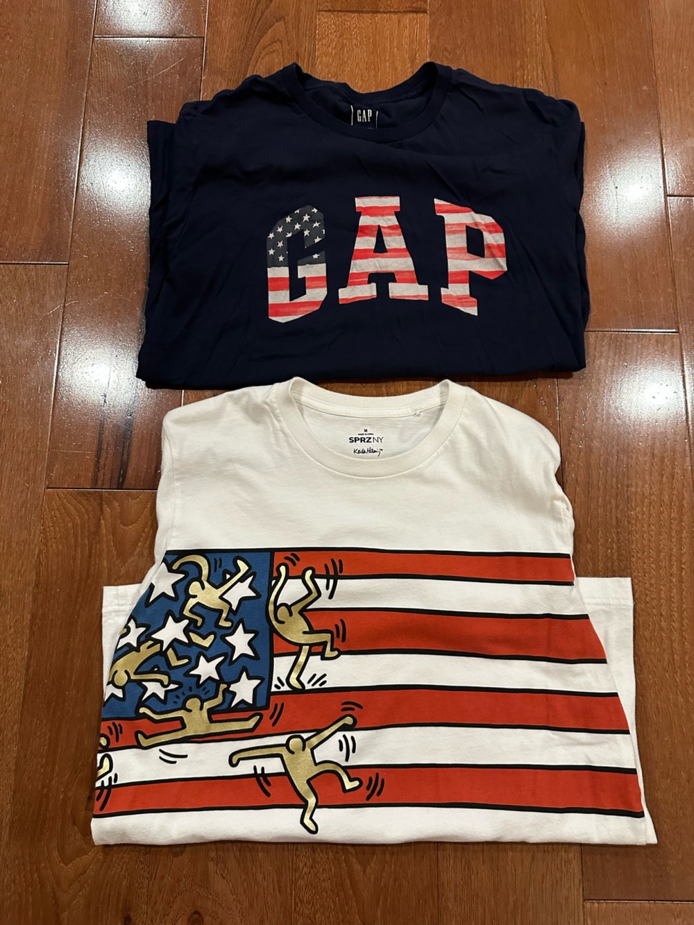 Two USA Flag Short Sleeve T-Shirts Gap and Uniqlo Keith Haring